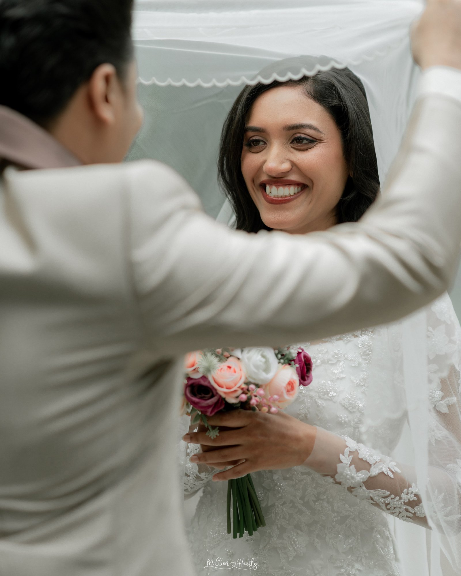 A bride and groom walking hand in hand in their wedding attire